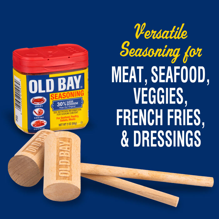 A jar of Old Bay seasoning with two wooden mallets.