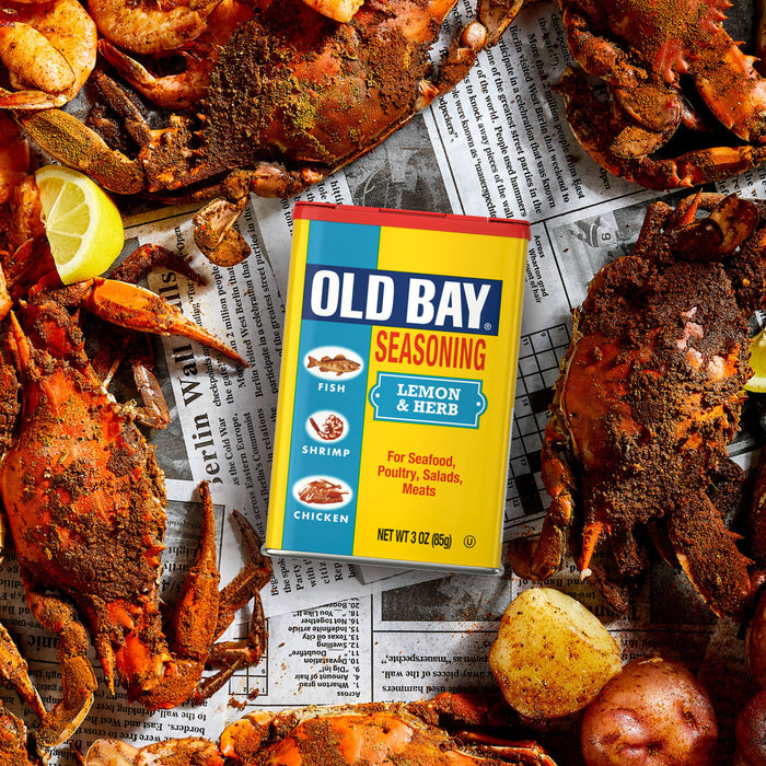 A can of Old Bay Seasoning is surrounded by cooked crabs and seafood, suggesting its use as a flavorful spice for seafood dishes.