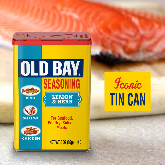 A can of Old Bay Lemon &amp; Herb Seasoning is displayed with a piece of salmon in the background.