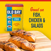 A can of Old Bay Seasoning is displayed next to grilled salmon, highlighting its versatility for fish, chicken, and salads.