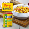 A can of Old Bay Seasoning is featured alongside a bowl of corn salsa, highlighting its savory and aromatic qualities.