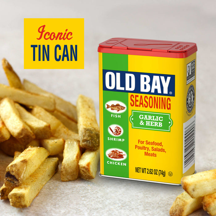 A can of Old Bay Garlic &amp; Herb Seasoning is displayed next to a pile of french fries, highlighting its versatility as a seasoning.