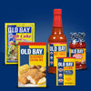 A collection of Old Bay products including crab cake mix, seasoned coating mix, hot sauce, cocktail sauce, and seasoning.