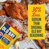 A can of Old Bay Seasoning with 30% less sodium is displayed alongside cooked crabs seasoned with the product.