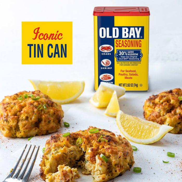 A tin of Old Bay Seasoning is featured with crab cakes and lemon wedges, highlighting its iconic status.