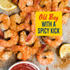 A close-up of Old Bay seasoned shrimp with a spicy kick, served with lemon wedges and cocktail sauce.