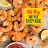 A close-up of Old Bay seasoned shrimp with a spicy kick, served with lemon wedges and cocktail sauce.
