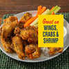 A plate of seasoned wings with carrot and celery sticks, next to a yellow box that says Great on Wings, Crabs &amp; Shrimp.