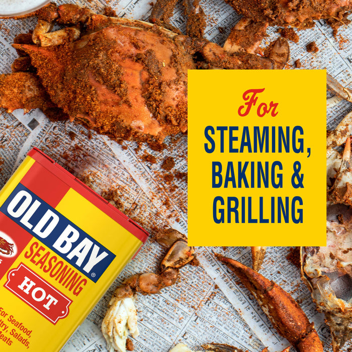 A can of Old Bay Hot Seasoning is displayed next to cooked seafood, highlighting its use for steaming, baking, and grilling.