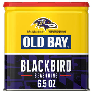 A yellow and purple tin of Old Bay Black Bird Seasoning, 6.5 Oz featuring the Baltimore Ravens logo as an official partner.