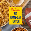 A bowl of popcorn seasoned with Old Bay Black Bird Seasoning, 6.5 Oz sits on a wooden table next to a football and pretzels for a game day snack.