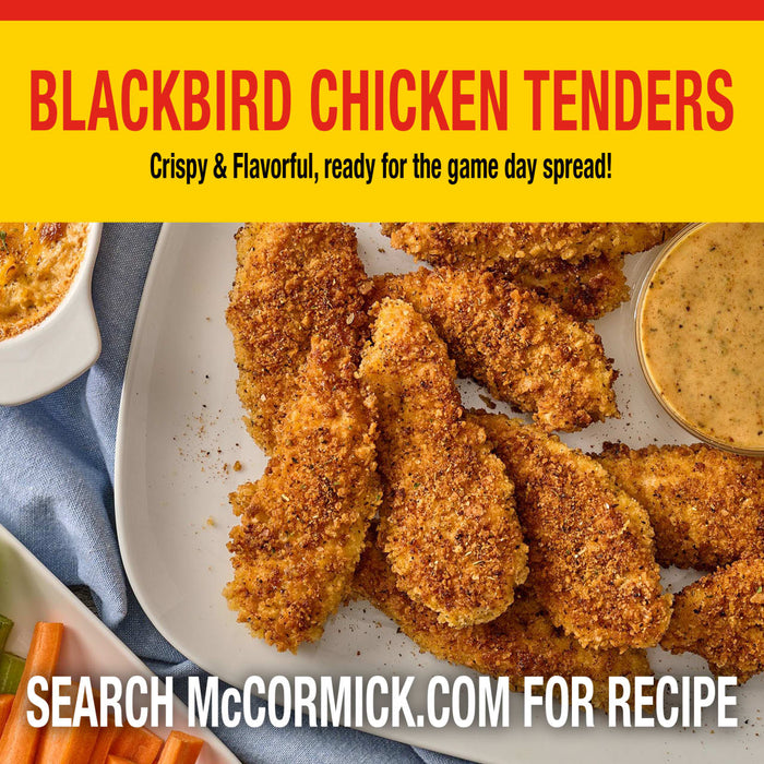 A platter of crispy Blackbird Chicken Tenders seasoned with Old Bay Black Bird Seasoning, 6.5 Oz served with a creamy dipping sauce and carrot sticks for a game day spread.