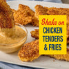 A golden brown chicken tender is dipped into a creamy sauce alongside a platter of crispy chicken pieces prepared with Old Bay Black Bird Seasoning 6.5 Oz.