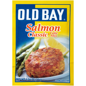 A package of Old Bay Salmon Classic Cake Mix with a serving suggestion of a salmon cake on a plate with asparagus and a lemon wedge.