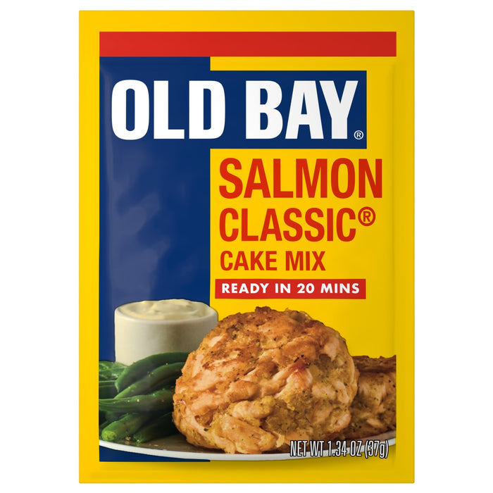 A yellow and blue packet of Old Bay Regular Salmon Seasoning Mix 1.34 Oz featuring a prepared salmon cake served with green beans and a side of dipping sauce.