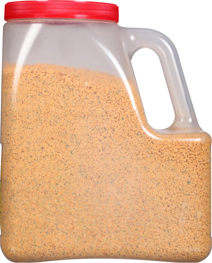 A plastic container filled with a yellow and green seasoning mix.