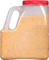 A plastic container filled with a yellow and green seasoning mix.