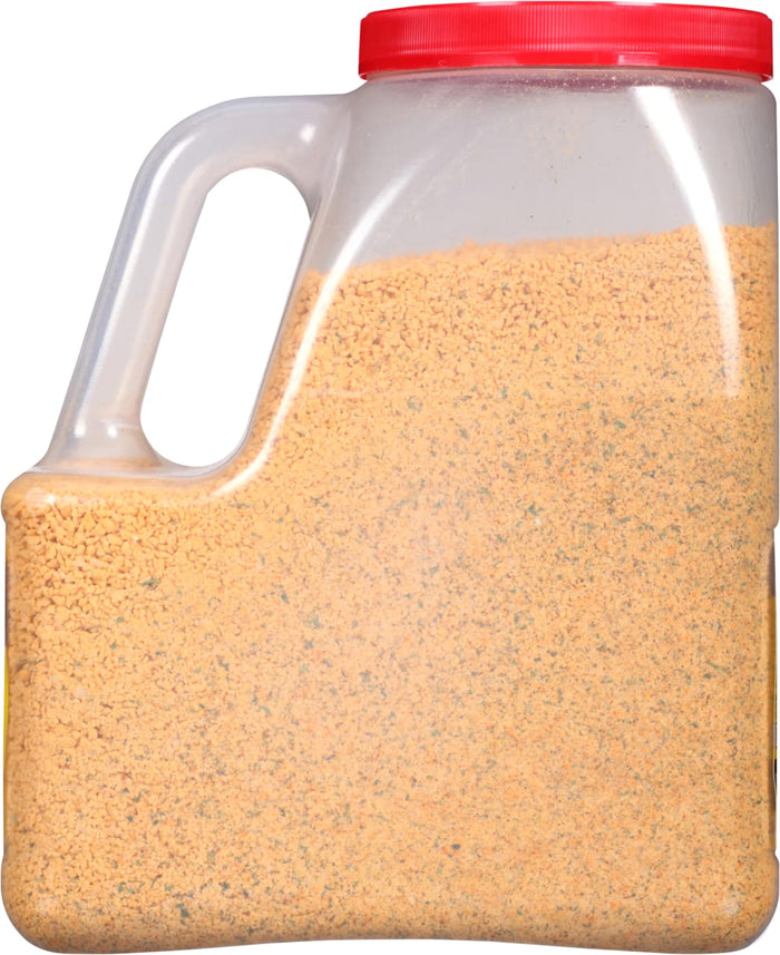 A plastic container filled with a yellow and green seasoning mix.