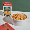 A box of Zatarain's Creamy Blackened Chicken with a bowl of the prepared dish.