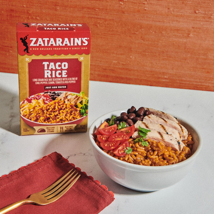 A bowl of Zatarain's Taco Rice with grilled chicken, black beans, tomatoes, and cilantro.