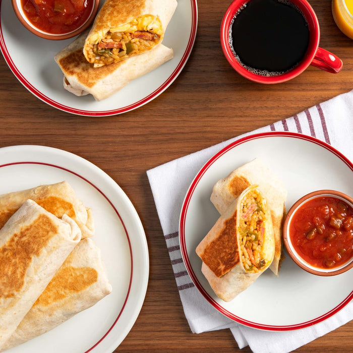 Three breakfast burritos are on white plates with red trim next to a cup of coffee and a small bowl of salsa.