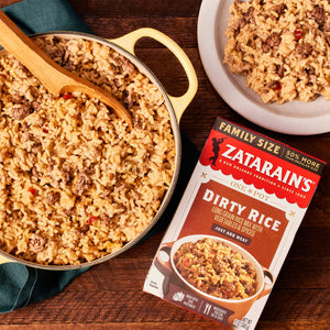 A box of Zatarain's Dirty Rice with a pot of cooked rice and a plate of rice.