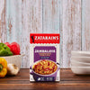 A box of Zatarains One Pot Jambalaya mix with a serving suggestion of peppers garlic and a bowl of cooked Jambalaya.