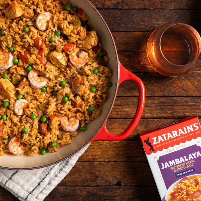 A red pot filled with Zatarains Jambalaya a dish of rice shrimp chicken and vegetables.
