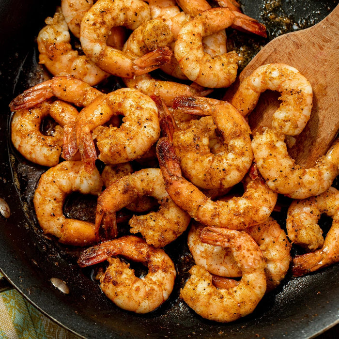 A close-up of a pan of cooked shrimp.