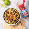 A bowl of black bean and corn salsa with McCormick Salt Free Roasted Garlic &amp; Bell Pepper Seasoning and tortilla chips.