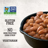 A close-up of Stubb'S Original Baked Beans, Canned Beans, 15.5 Oz., 12-Count in a cast iron skillet highlights that the product is Non-GMO Project Verified, gluten-free, vegetarian, and contains no high fructose corn syrup.