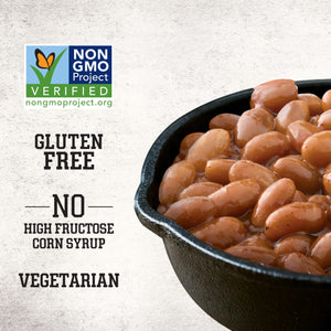 A close-up of Stubb'S Original Baked Beans, Canned Beans, 15.5 Oz., 12-Count in a cast iron skillet highlights that the product is Non-GMO Project Verified, gluten-free, vegetarian, and contains no high fructose corn syrup.