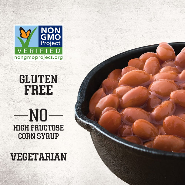 A close-up of Stubb'S Sticky Sweet Baked Beans, Canned Beans, 15.5 Oz. in a black skillet highlights its Non-GMO, gluten-free, and vegetarian qualities.