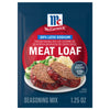 A package of Mccormick Regular Meat Loaf Seasoning Mix 1.25 Oz is shown in front of a prepared dish of meatloaf with mashed potatoes and peas.