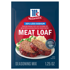 A package of Mccormick Regular Meat Loaf Seasoning Mix 1.25 Oz is shown in front of a prepared dish of meatloaf with mashed potatoes and peas.