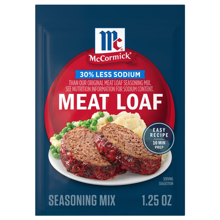 A package of Mccormick Regular Meat Loaf Seasoning Mix 1.25 Oz is shown in front of a prepared dish of meatloaf with mashed potatoes and peas.