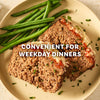 Two slices of meatloaf topped with melted cheese and sauce, served with a side of green beans, illustrate a convenient weekday dinner made with Mccormick Regular Meat Loaf Seasoning Mix 1.25 Oz.
