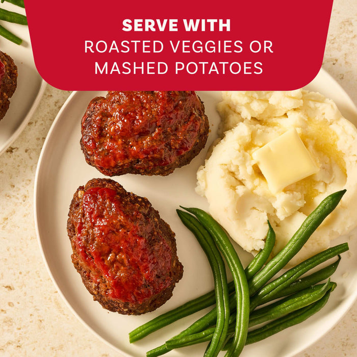 A delicious serving suggestion for Mccormick Regular Meat Loaf Seasoning Mix 1.25 Oz shows a plate with two mini meatloaves, mashed potatoes with butter, and fresh green beans.