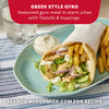 A delicious-looking Greek-style gyro, filled with seasoned chicken, fresh vegetables, and tzatziki sauce, is served on a plate with french fries, showcasing a recipe idea that can be made with a Mccormick Regular Sauce And Seasoning Mix Envelope 1.5 Oz.