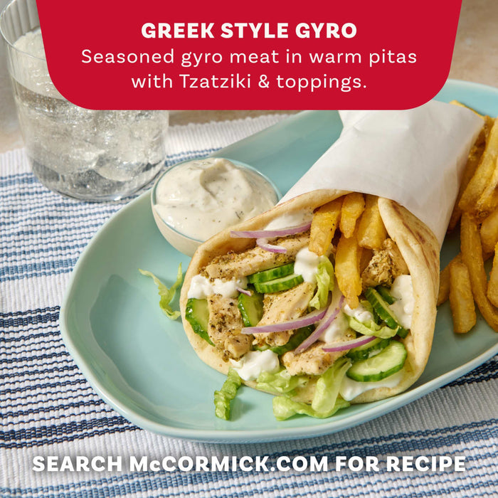 A delicious-looking Greek-style gyro, filled with seasoned chicken, fresh vegetables, and tzatziki sauce, is served on a plate with french fries, showcasing a recipe idea that can be made with a Mccormick Regular Sauce And Seasoning Mix Envelope 1.5 Oz.