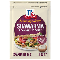 A front view of the Mccormick Regular Sauce And Seasoning Mix Envelope 1.37 Oz for Shawarma Pita with Garlic Sauce, featuring a serving suggestion of a pita filled with chicken, vegetables, and garlic sauce.