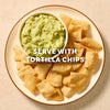 A bowl of fresh guacamole, prepared with Mccormick Regular Seasoning Mix 1 Oz, is served on a plate surrounded by tortilla chips.