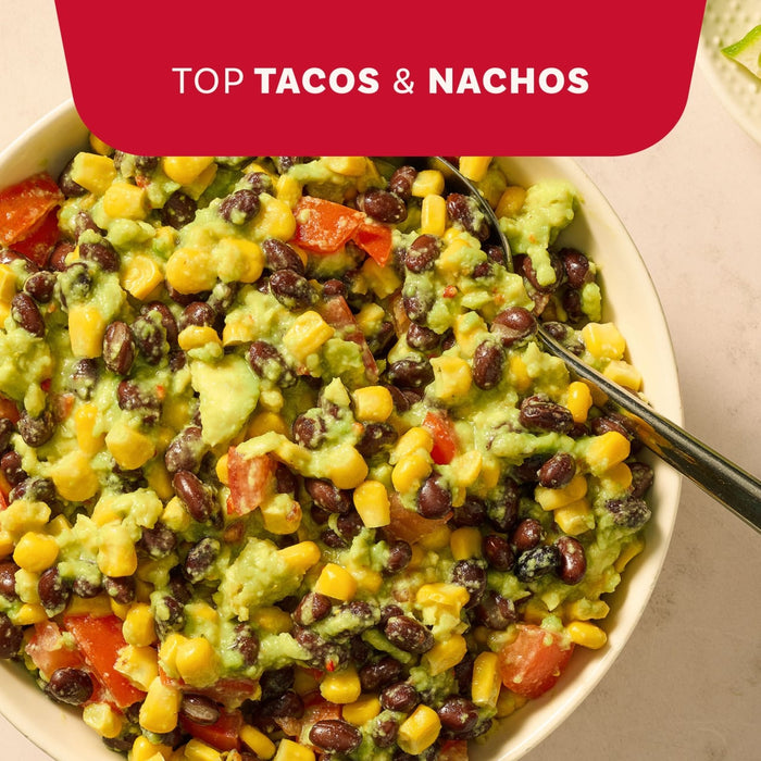 A vibrant bowl of black bean and corn dip with avocado makes a great topping for tacos and nachos when prepared with Mccormick Regular Seasoning Mix 1 Oz.