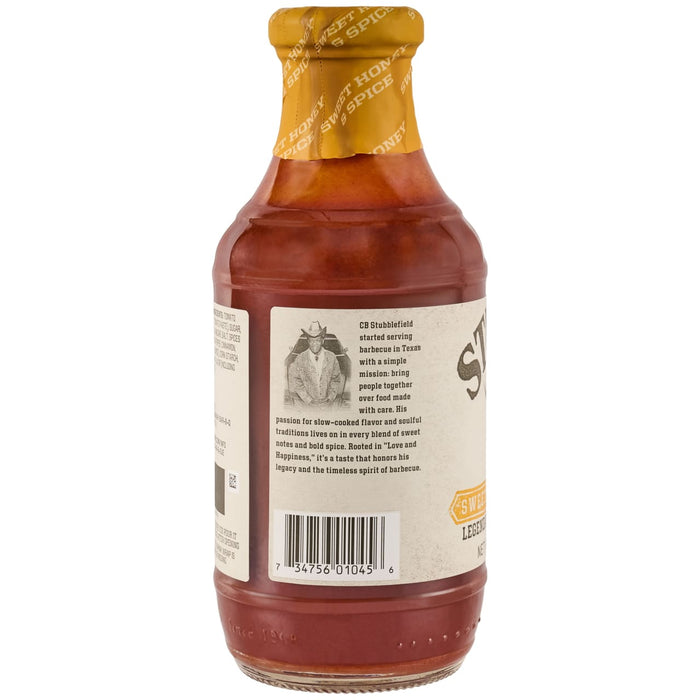 A back view of a Stubbs Sweet Honey &amp; Spice Barbeque Sauce Glass Bottle 18 Oz featuring a brief history of the brand founder CB Stubblefield and a barcode on the label.