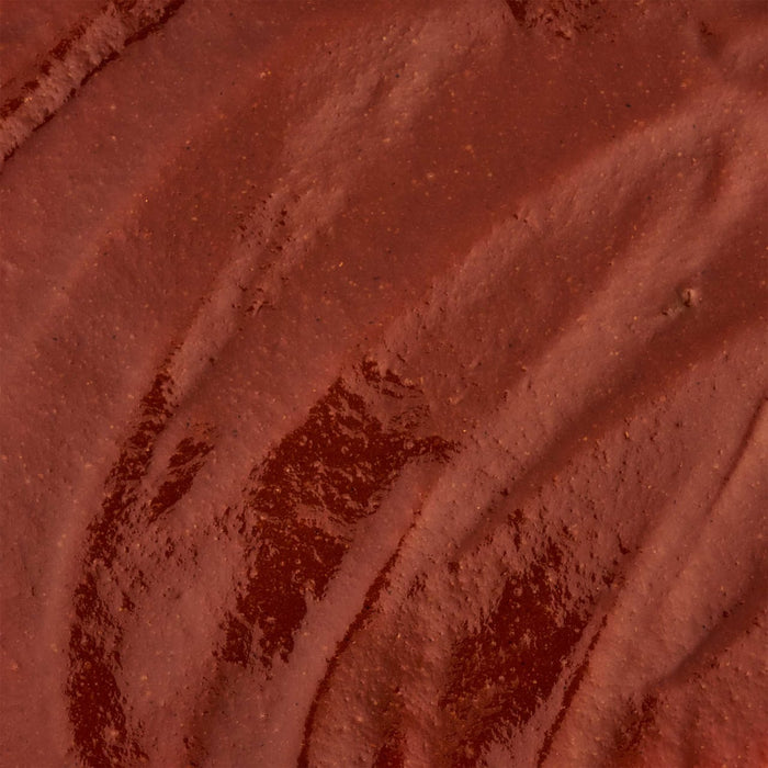 A close-up of a textured, reddish-brown surface with subtle, flowing patterns.
