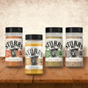 A variety of Stubb's spice rubs are displayed on a wooden surface.