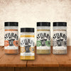 A variety of Stubb's spice rubs are displayed on a wooden surface.