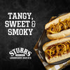 A close-up of two hot dogs topped with a tangy, sweet, and smoky sauce, featuring the Stubb's Legendary Bar-B-Q logo.