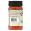 The back of a bottle of Stubb'S, 5.07 Oz Garlic Lime Flavored Seasoning shows the product description and usage suggestions against a background of the red spice blend.
