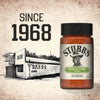 A bottle of Stubbs Grlc Lime E seasoning is displayed next to a vintage black and white photo of the original barbecue restaurant and the text Since 1968.
